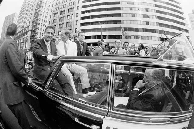 Mayor Daley escorts astronauts down Wacker Drive to ticker tape parade on Michigan Ave and La Salle Street,but seems to have something else on his mind.