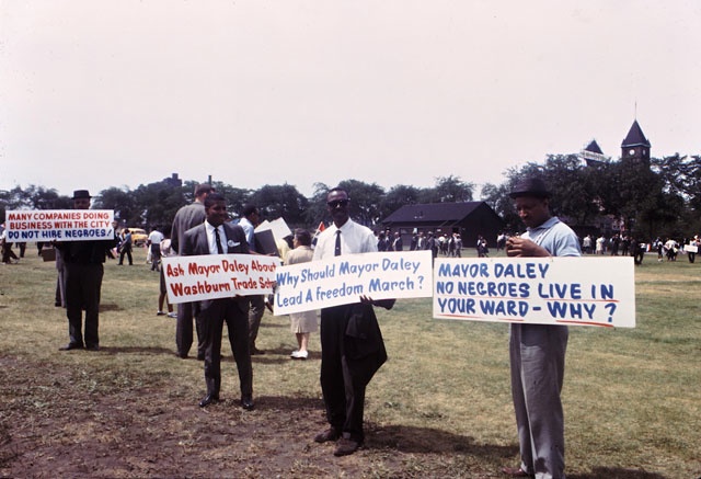 Along the route to McCormick Place, 1963 pickets politely make their points.
