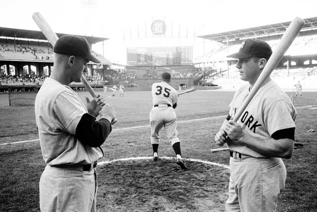 Maris and Mantle at Comiskey Park the week before Maris broke the Babe\'s home run record. In 1951 I was assigned by \<em\>Time\<\/em\> to shoot the visiting Yankees\' surging Mantle for a cover - that is, a portrait their hand artist could copy. In the lockerroom little Phil Rizzuto came out of the shower with a towel wrapped around his middle. \"Hey kid,\" he said. \"You\'re a photographer with a darkoom, right?\" \"Yeah,\" I said shyly, still uncomfortable talking to the mighty. Rizzuto dropped the towel and held out his tiny penis  with two fingers.\"How about having this enlarged?\" Even DiMaggio laughed as I blushed.