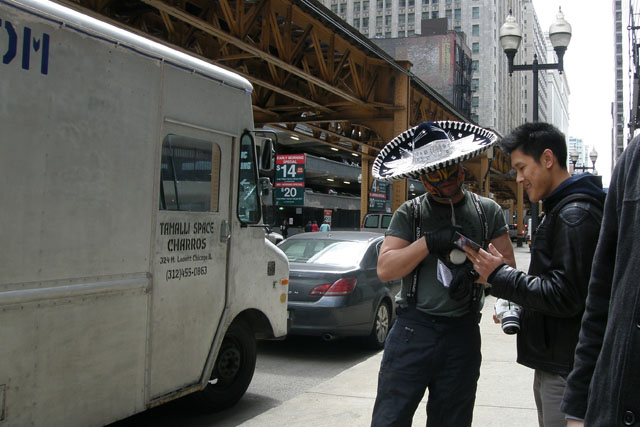 A luchador shares the menu with pedestrians