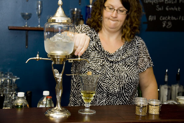 North Shore\'s Sonja Kassebaum provides an impromptu demo of the traditional absinthe preparation La Louche, dripping cold water over a sugar cube.