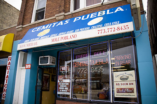 The storefront of Cemitas Puebla announces the restaurant\'s appearances on \"Check, Please!\" and \"Diners, Drive-Ins and Dives.\"