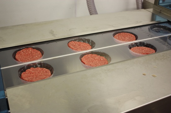 Hamburgers in the packaging machine.
