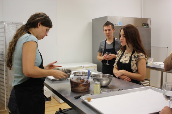 Katherine, showing students how to stir melted chocolate.