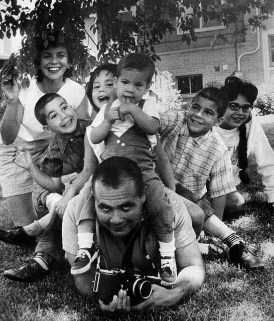In a 1961 promo picture for the Saturday Evening Post, Florence and I parenthesize our brood: Richard, Lauren, Steve, Harmon and Jane. The camera hiding my hand-release for a  small Canon?  A new Nikon capable of shooting 250 pictures at 3.5 frames a second on one 30-foot spool of film.  For real camera avatars: Nikon based its design on the 250-exposure Leica  made for the Luftwaffe. I\'m sure one of the originals, a time or two (mounted on a Focke-Wulf 190 or Messerschmidt  gun camera), had my bomber, \<i\>Sweet Sue\<\/i\>, in its sights. It was all connected even then.