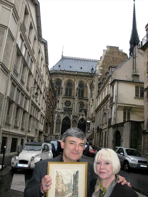 Friends of Florence and mine, two part-time Parisian Lake Foresters, Craig and Eva Quackenbush, show off a\r\nfamous etching of the street their apartment is on, close to Notre Dame Cathedral behind them.\r\n\r\n