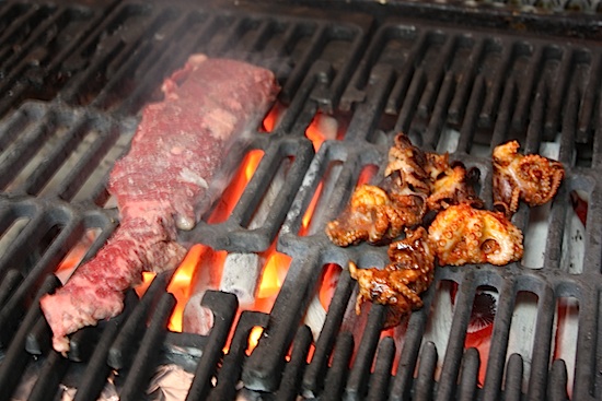 Octopus and steak on the grill.