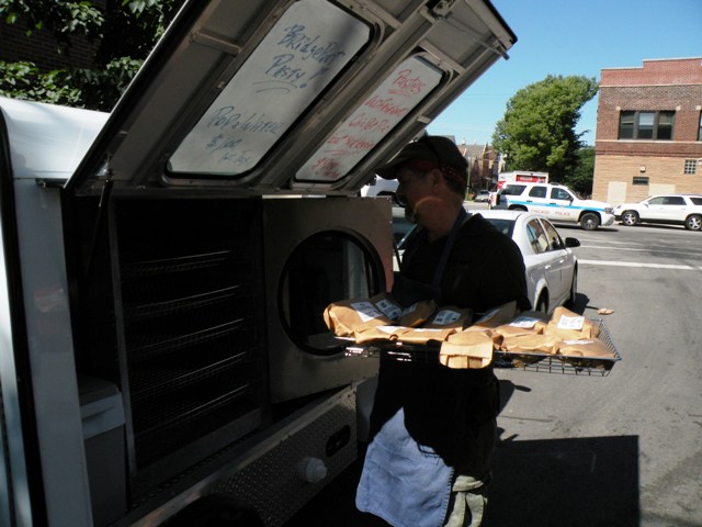 Bridgeport Pasty\'s Jay Sebastian loading up the Pastymobile for the Newberry Book Fair in July. (Chuck Sudo/Chicagoist)