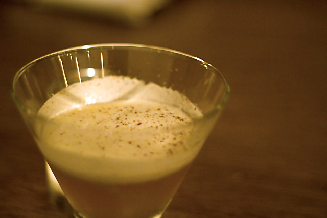A bourbon and apple cocktail, garnished with foam and fall spices.
