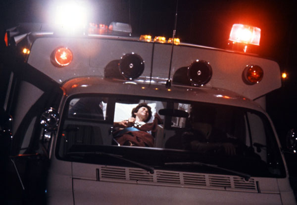 Florence, posing as an accident victim in ambulance, for a Blue Cross book jacket. (Â© Art Shay)