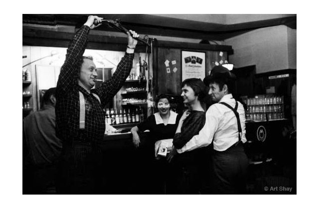 At an Irving Park restaurant, Algren, left, displayed an historic gun to Marceau and his date, the beautiful poet and T.S.Eliot expert, Dorothy Terry. Terry was chief writer of Marlin Perkins\' TV show, Zoo Parade.