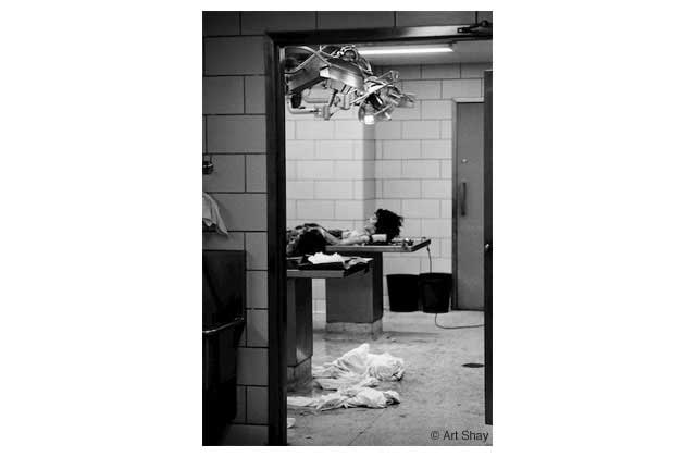Two of the slaughtered nurses in the Chicago morgue. I got this picture with a 21 mm wide-angle lens on the Leica, playing to the vanity of the coroner who posed in the hall as I shot past him at the gruesome scene.