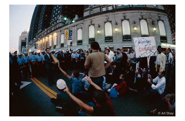 Protest by the Hippies, right, and the cops left in front of the Palmer House Hilton in Chicago. When Jesse Jackson\'s cotton wagon mules pushed the Hippies into the Hilton shop windows, the police went berserk: \"a police riot\" the Walker report called it.\r\n