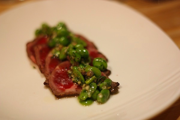 Hand-cut beef carpaccio with fava beans and peas.
