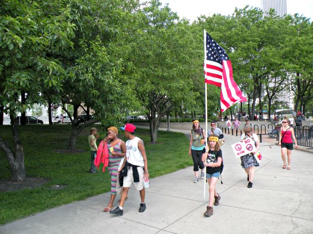 A young girl brings a flag to the rally.