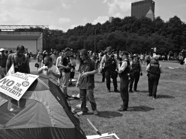 Chicago Police ask three protesters who came to Chicago from the West Coast to take down their tents.