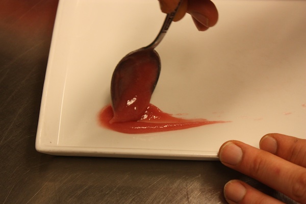 Swooshing a rhubarb reduction onto the plate.
