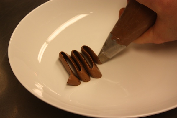 Beginning the \"Dark Chocolate, Peanut\" with chocolate cream.