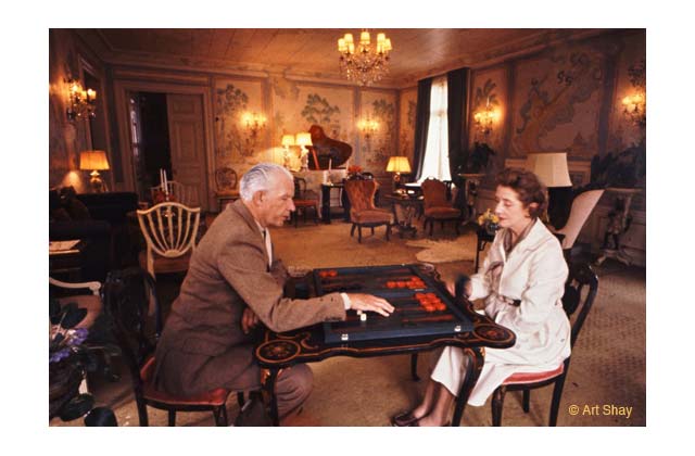 While playing cribbage (their board game passion) in their living room, Lynn casually mentioned that the chair visible at left was Noel Coward\'s favorite. in it, Coward broke up repeatedly at the cleverness of his lyrics for \<em\>Mad Dogs and Englishmen\<\/em\>, especially the line about \"every Malay rabbit makes it a habit\" to find shelter from the sun... but not Englishmen. She also noted the great critic and raconteur Alexander Woolcott preferred the chair on the right: \"the one you are occupying, Arthur.\" I was thrilled and honored.\r\n