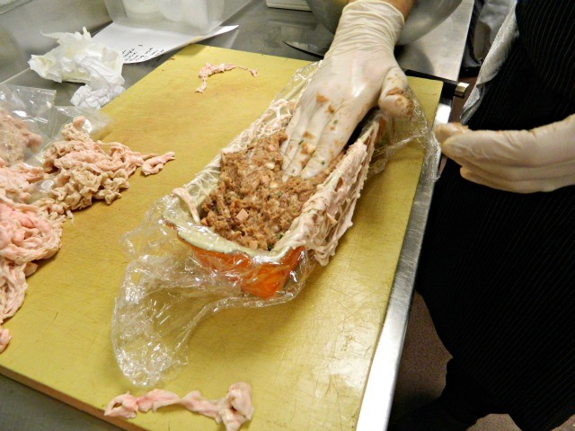 Zimmerman packs the pate into the mold.