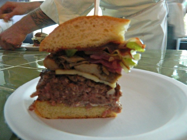 Dirk Flanigan, Henri/The Gage\r\n\r\nThe Grand Veneur: USDA Prime chuck burger, smoked Gouda, woodland mushrooms, pickled onions, lettuce, pickles, roasted onions, jalapeno, red wine ketchup, and mustard aioli on a brioche bun.
