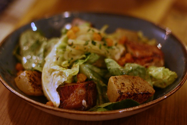 a \"down south\" lyonnaise salad with pork belly, crispy pig ears and pickled apple.