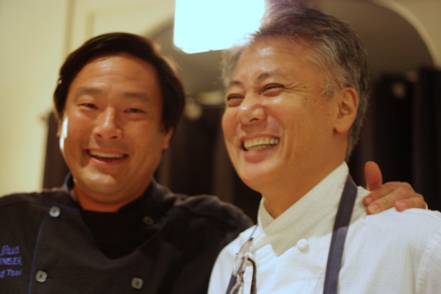 The two chefs, laughing together.
