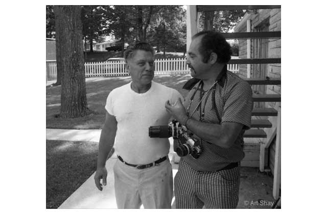 Former Teamsters Union leader Jimmy Hoffa and me outside his home near Detroit in the 70\'s. He warned me not to stand \"too close\" to him because he felt himself a target-coming back from prison and reentering the labor wars. Three months later he disappeared and his body was variously rumored to have been ground up in a dog food machine, or buried under the end zone of a new football stadium. I covered one futile farmyard dig. He was full of Detroit lore, passing a Fox & Hounds restaurant he pointed to an Oldsmobile. \"Henry Ford II  was having lunch here one day with some of his younger  geniuses. He casually said, .\>\"Why don\'t we have a car competing head to head with that Oldsmobile?\" His ass-kissing boys then proceeded to design, promote and fail with the Edsel. So said Jimmy Hoffa.\r\n