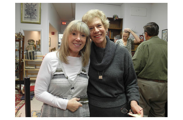 Key employees of Florence\'s: Simone Goodman was with her for 26 years and at the right, Karyn Goldstein again, will \"woman\" the remaining shelves until closing day, Dec. 31. The exasperated  lady in charge of the auction, Mary Kashoke, momentarily holds the head that has masterminded the final chapter of poor Florence\'s 40-year run with her beloved Titles, Inc. Beloved and world-renowned. The big guy at the right is old customer and Florence fan Carlos Martinez. Carlos is deaf and he came with his wife, Ofelia, to help him shop at Titles one last time.\r\n
