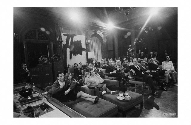 In the fabled Main Room, Hef\'s guests await a screening of the latest James Bond movie. A few years later Hef\'s PR department invited Florence and me to a wild \"Hollywood party\" beginning at midnight, We arrived sleepily, saw a sprinkling of \"names\"&mdash;William Buckley , Adlai Stevenson,  Joan Blondell&mdash;but aside from some of the dancing, not unlike one of our own playroom gatherings. We left at 2 a.m. Noon the next day Hef\'s secretary calls: \"Wasn\'t that wild? Buckley doing that headstand! \" Into my embarrassed silence she said, \"You left at TWO?\" And laughed. \"Nothing begins around here before 3 a.m.!\" We promised to stay longer next time.