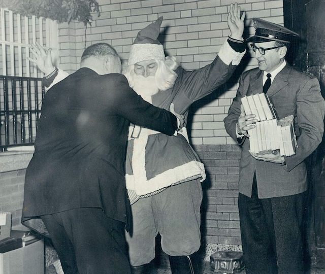 Santa gets a pat down at City Jail, 1965, Chicago.