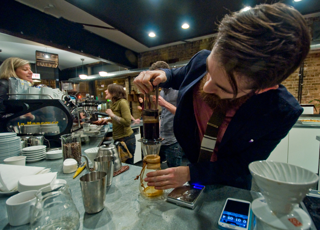 Robbie Krask prepares coffee using an AeroPress.
