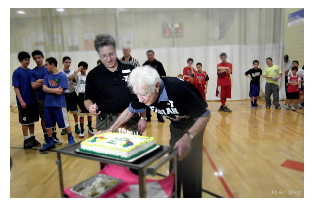 Northbrook YMCA Executive Director Howard Schultz stage manages Max: \"Fill your lungs with air, Max,\" he directs. \"Now let it all out.\" Perfect blow-out of the 104 candles plus one for good luck. He keeps his weight a trim 130 pounds.