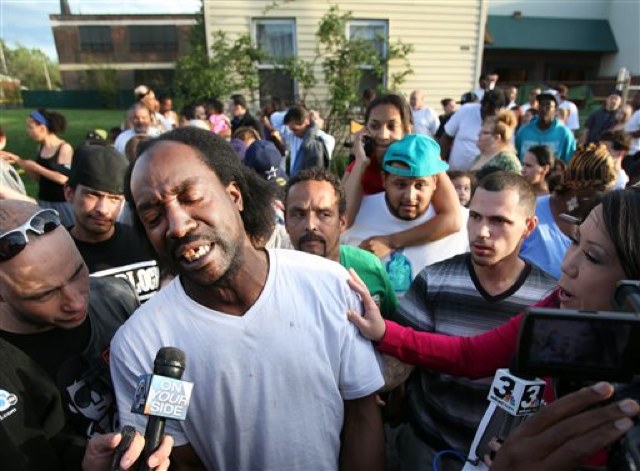 Charles Ramsey, surrounded by neighbors and reporters